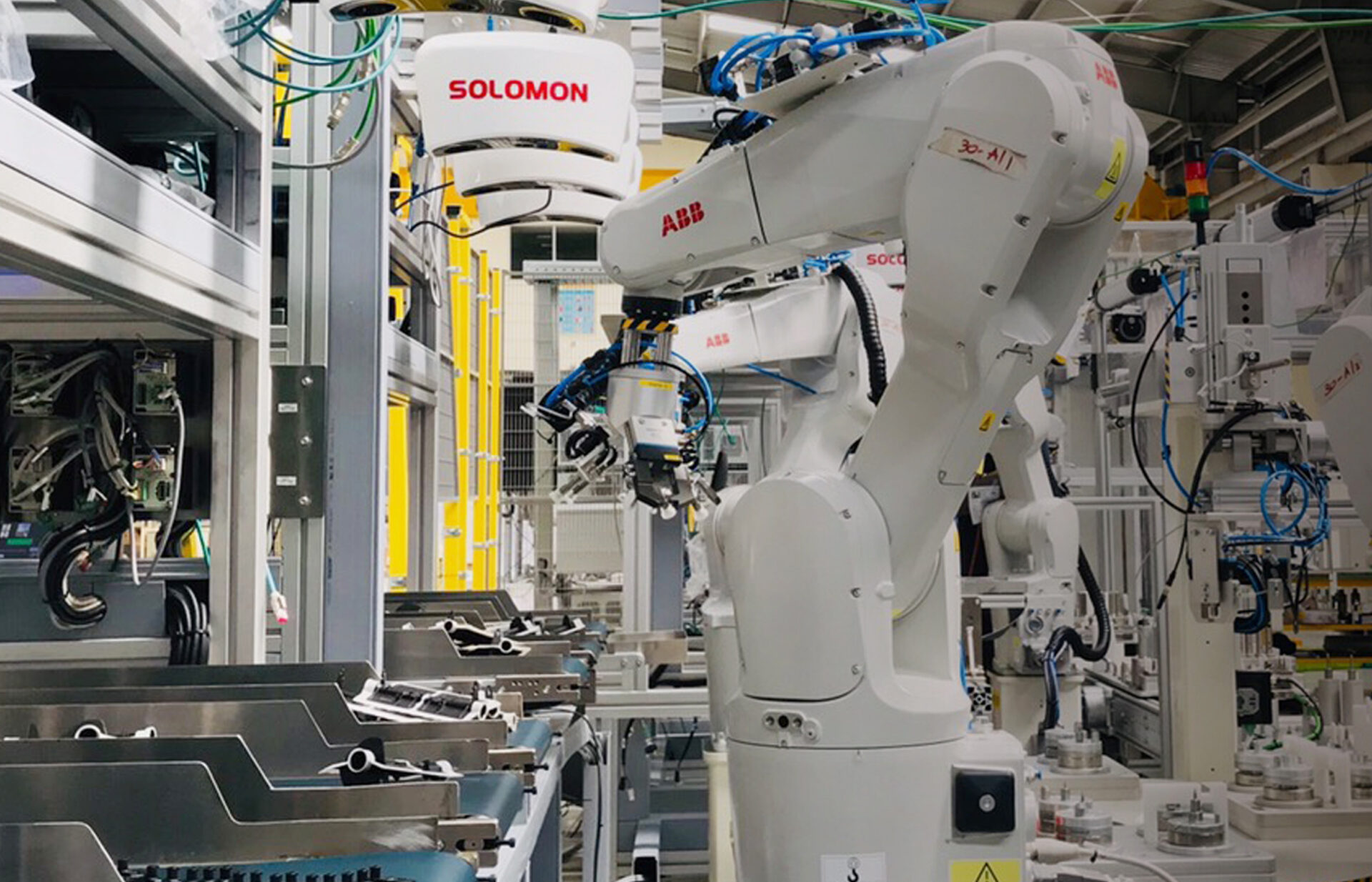 an ABB robot on an automated assembly line arm conducts a kitting task using Solomon AI and 3D vision technology