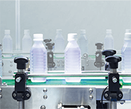 Food and Beverage plastic bottles on a green conveyor