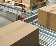 E-commerce cardboard boxes on a conveyor inside a distribution center